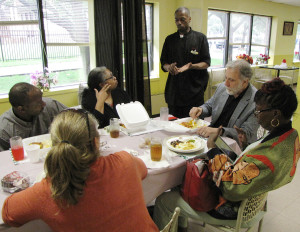 Richard Cammarieri, seated at head of table, NCC Director of Special Projects, gave a tour of New Community to a group of residents from Baltimore, Md., who are creating a new community development corporation in a Baltimore neighborhood called McElderry Park. The visitors discussed NCC’s history with Cammarieri during lunch, which was prepared by staff at the Culinary Cafe, and met with Sam Gaddy, standing, Assistant Instructor of NCC’s Culinary Arts Specialist Program.