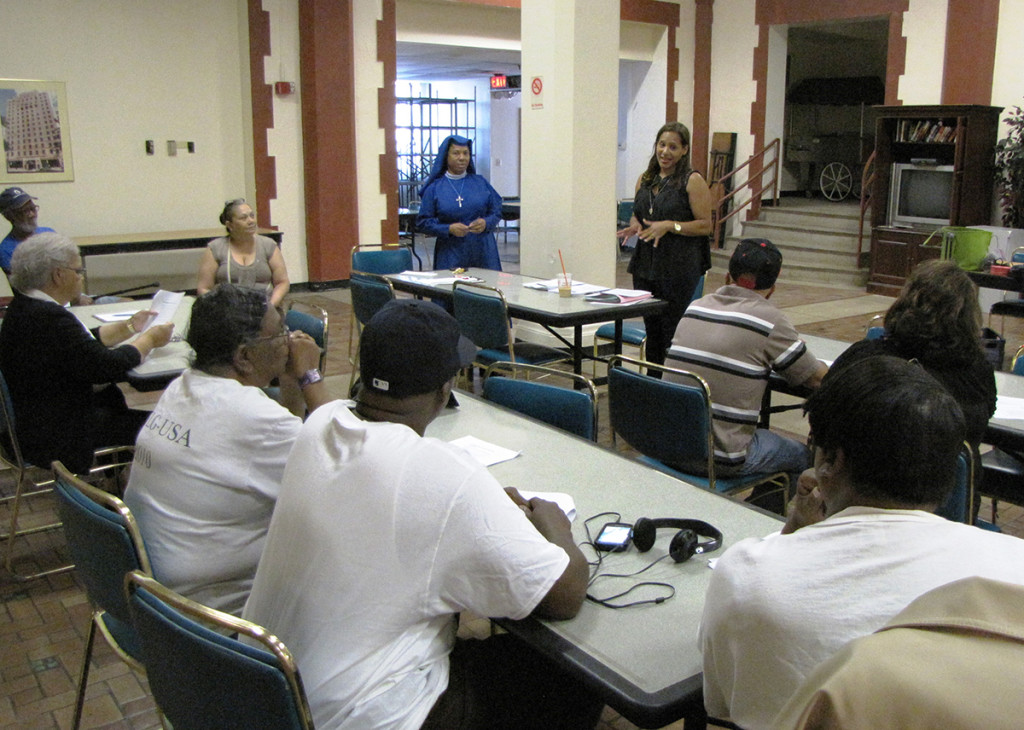 Milda Rosa, standing center, a Community Educator with New Jersey Citizen Action, spoke to seniors at NCC Douglas Homes about how to guard against identity theft, scams and fraud.