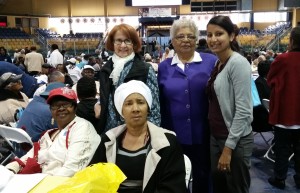 Care Coordinator Jasminee Sawh-Ramroop, right, and four seniors from New Community, participated in health screenings and exercise demonstrations. Seniors also received bagged produce from a farmers market and free admission to Turtle Back Zoo.