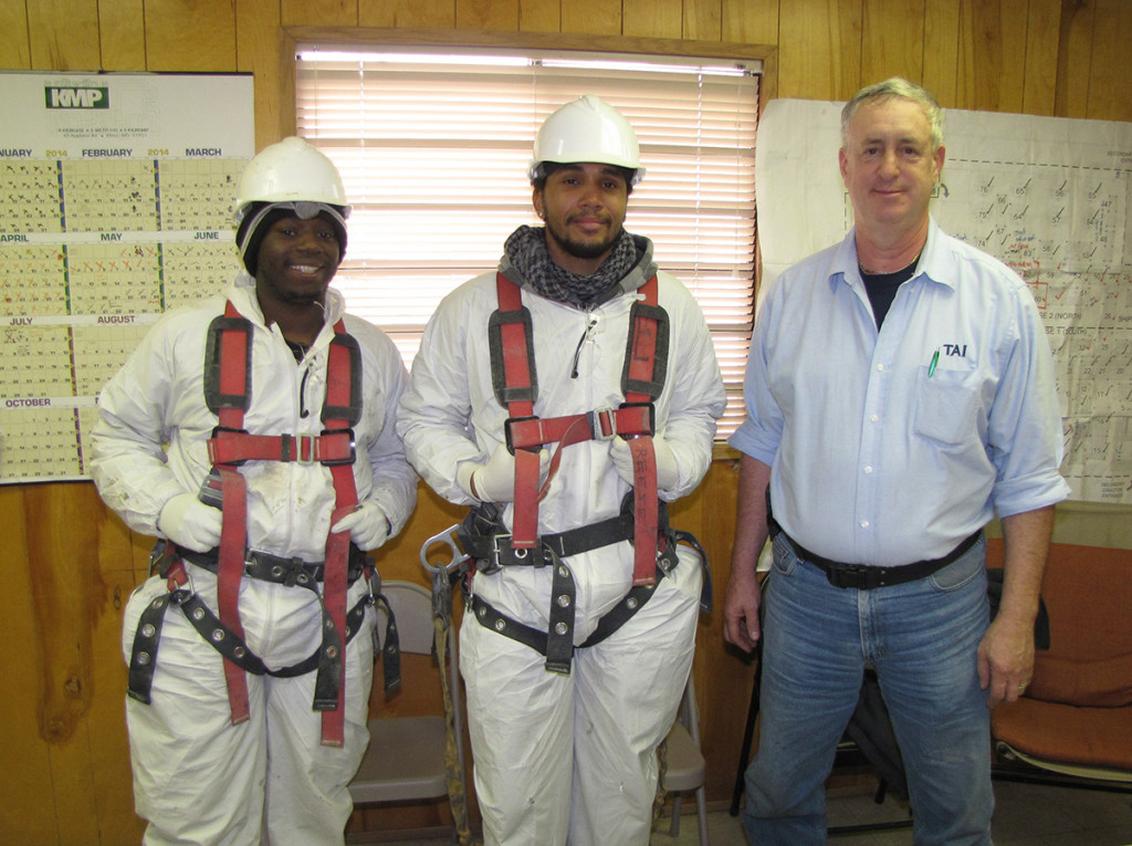 From left: NCC Building Trades Training Program students Maurice Culley and Emiliano Jones stand with their supervisor, George Finch, Fiberglass and Coatings Division Manager for TAI Specialty Construction, at their work site in South Kearny.