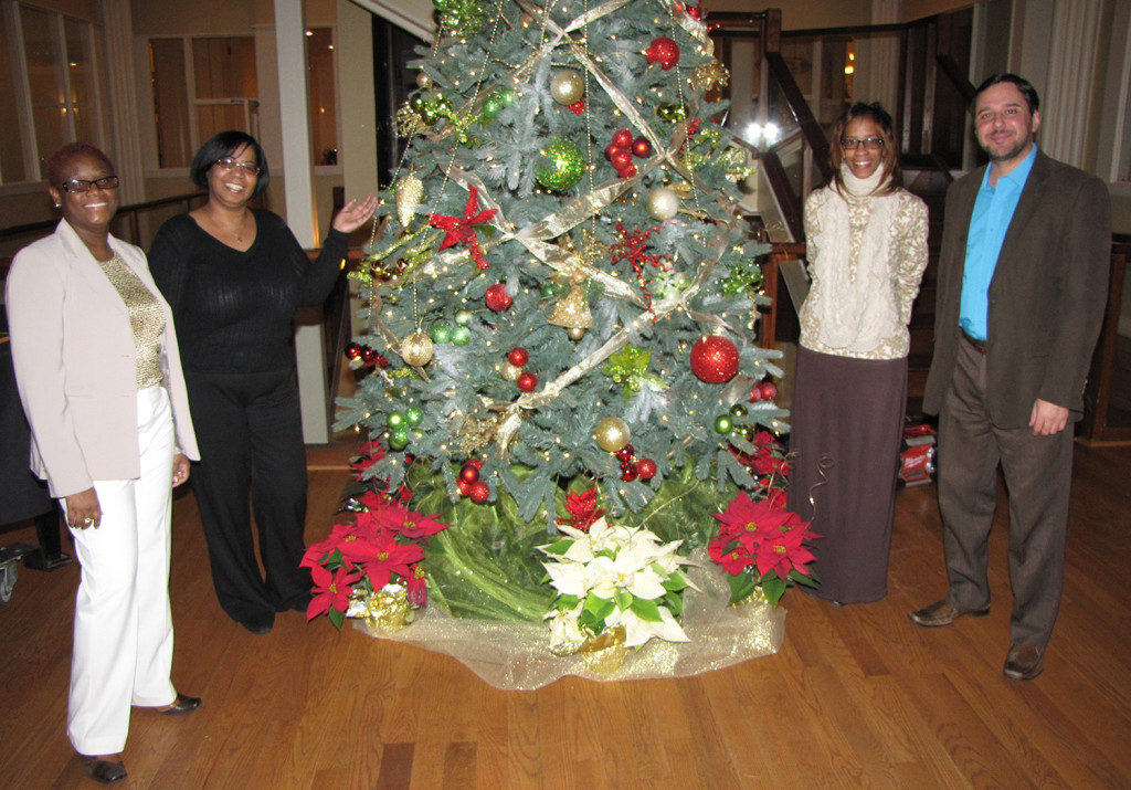 O Christmas Tree! From left: Anna Sing-King, Manager of Human Resources, Jackie Andrews, Program Manager of SAIF, Lisa Chavis, Senior Case Manager at Harmony House, and Cristhian Barcelos, Director of the NCC Adult Learning Center.