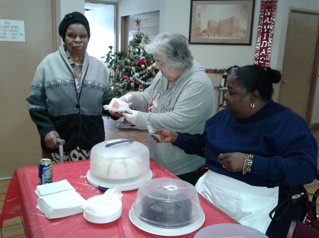 Manor Senior resident Doris Okaro, far left, purchases a slice of cake from Patricia Hulon, center, as Cynthia Sears, right, hands her change. The bake sale raised money for the Manor Senior Tenant Association, of which Sears is the President. Photo courtesy of Sister Mary Prisca.
