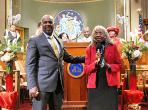 Newark Mayor Ras Baraka, left, with New Community Associates resident Elnora Haynes, right, as Haynes receives the Unsung Heroes and Heroines Award in the Municipal Council Chambers at City Hall on May 4, 2015.