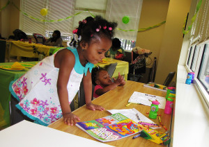 Destiny, foreground, age 2, and her younger sister, Ebony, age 1, colored pictures while attending the event with their mother, Tamara White, not pictured. 