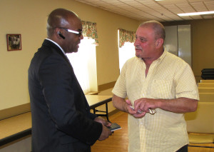 Atanasildo Fleitas, right, a resident of Orange Senior, discussed his questions with Rodd Henson after the presentation.