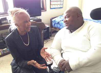 Madge Wilson, left, visits Vietnam veteran Nathaniel Lawrence at his apartment at New Community Associates in Newark.
