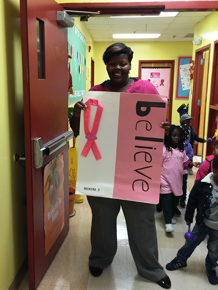 CHELC breast cancer teacher holding sign