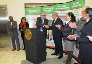 Richard Rohrman, at podium, CEO of New Community, introduced U.S. Sen. Robert Menendez, to the right.