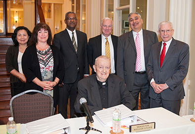 Monsignor William J. Linder, center seated, with fellow board members of the New Jersey Housing and Mortgage Finance Agency and Executive Director Anthony Marchetta, second from right.