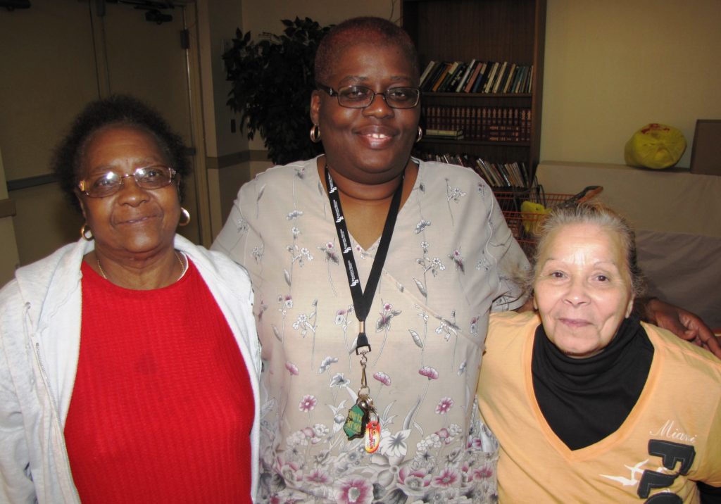 Doreatha Wertz, center, is a care coordinator at New Community Commons Senior, where she assists residents such as Madelyn Derrick, left, and Alma Rivera, right.