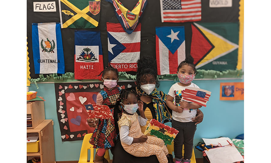 CHELC Black History Month 2022 Students with flags and teacher for web