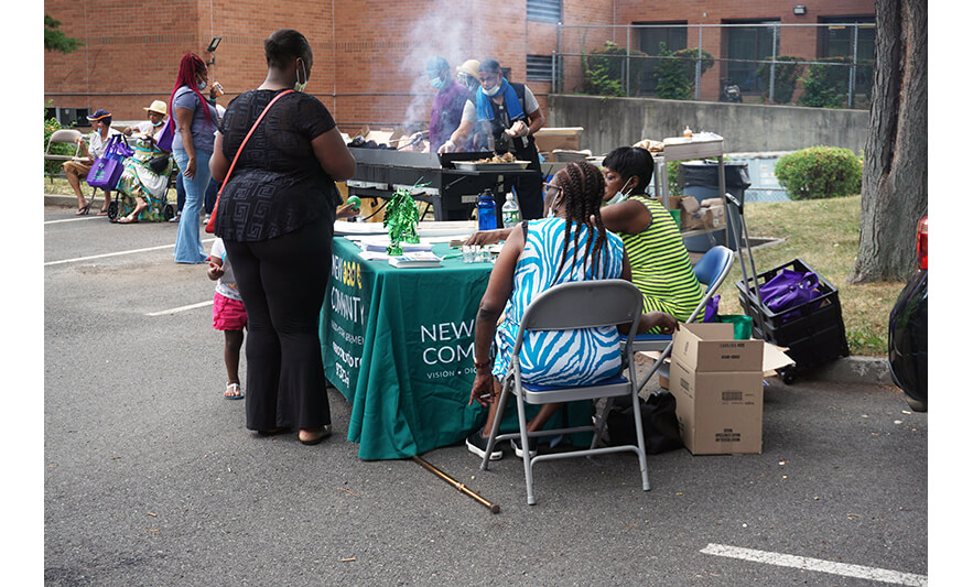 Extended Care Health Fair 7-29-2022 Family Resource Success Center Table with woman in black for web