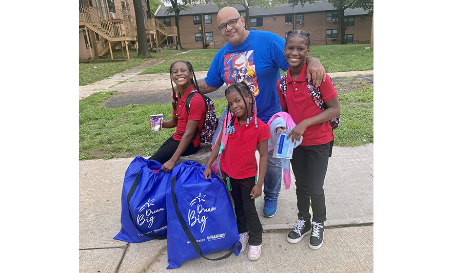 Resident Services Back 2 School Store 2022 Anibal Alvelo with three girls for web