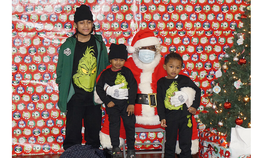 Breakfast with Santa 12-17-2022 Kids in Grinch shirts with Santa for web