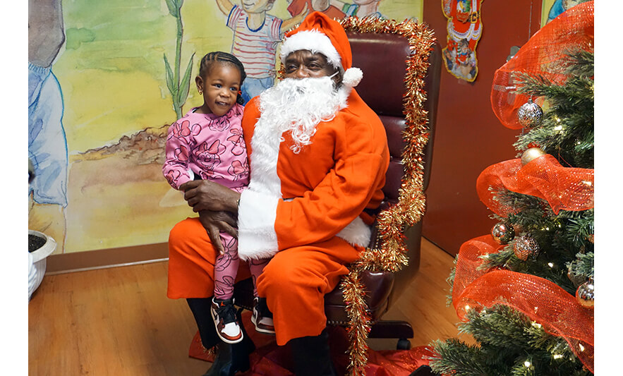 CHELC Santa Visit 12-16-2022 Girl in Minnie outfit with Santa for web