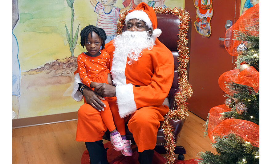CHELC Santa Visit 12-16-2022 Girl in heart dress with Santa for web