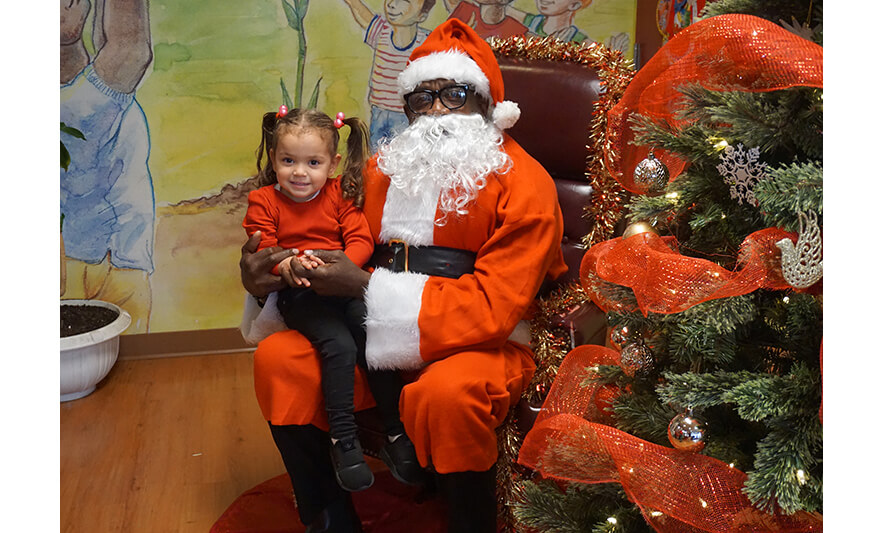 CHELC Santa Visit 12-16-2022 Girl in pigtails smiling for web