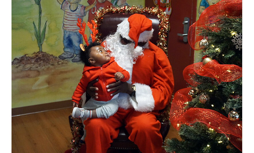CHELC Santa Visit 12-16-2022 Infant looking at Santa for web