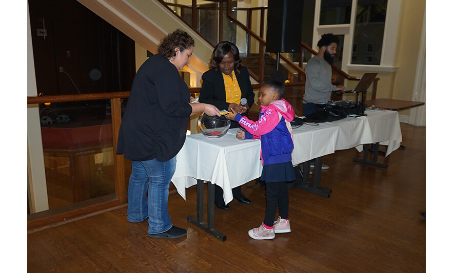 Withum Harmony House Thanksgiving Dinner 11-21-2022 Girl in pink getting gift card for web