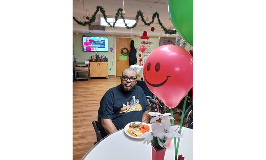 Extended Care Christmas 12-14-2022 Man with balloon for web