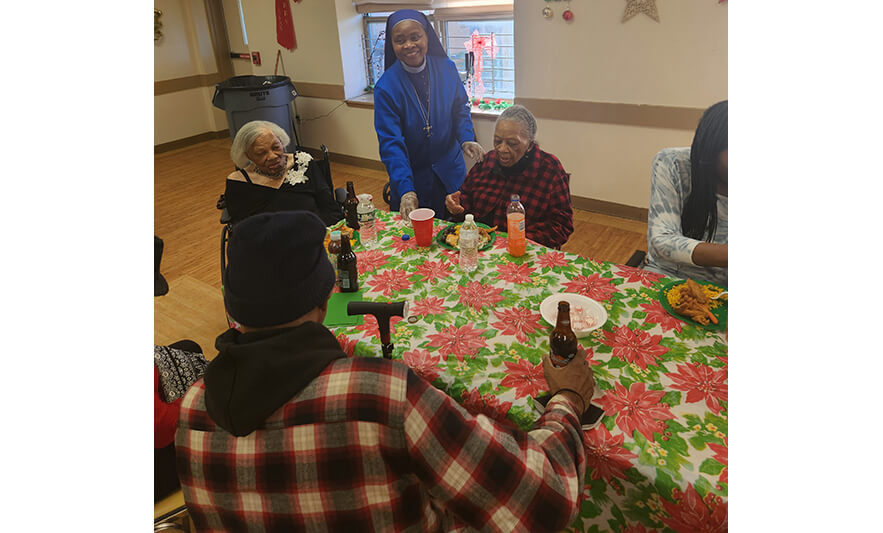 Orange Senior Christmas Party 12-21-2022 Sister Pauline with residents for web
