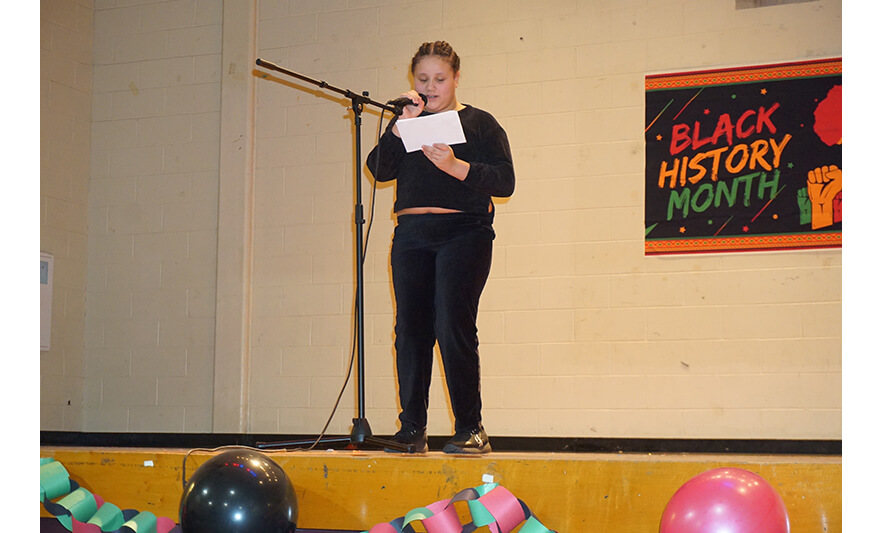 Youth Services Black History Month Program 2-24-2023 Girl in black reading short poem for web