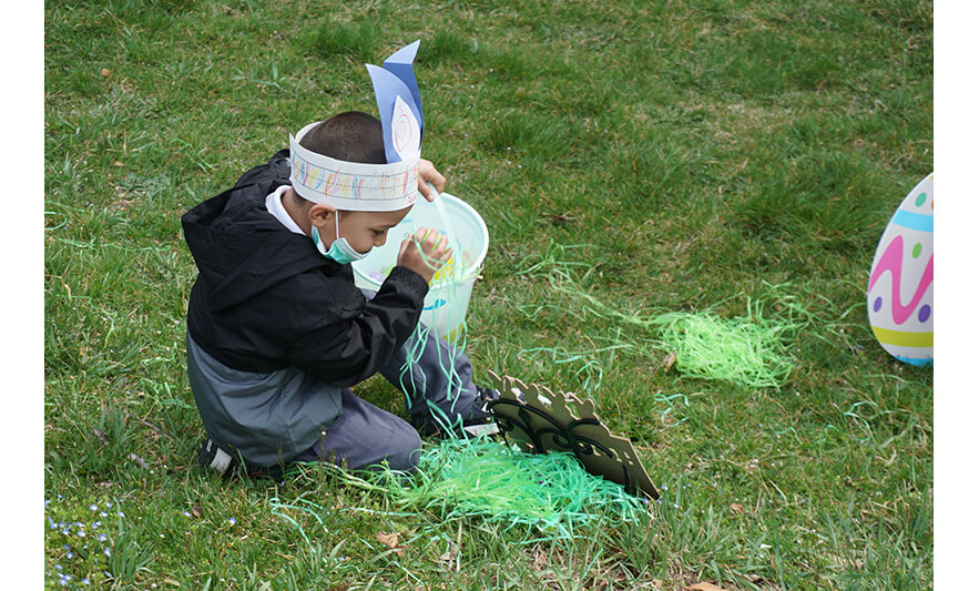 CHELC Easter and Family Fun Day 4-6-2023 Boy getting egg and Easter grass for web