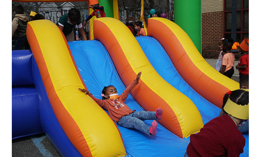 CHELC Easter and Family Fun Day 4-6-2023 Girl on inflatable slide for web