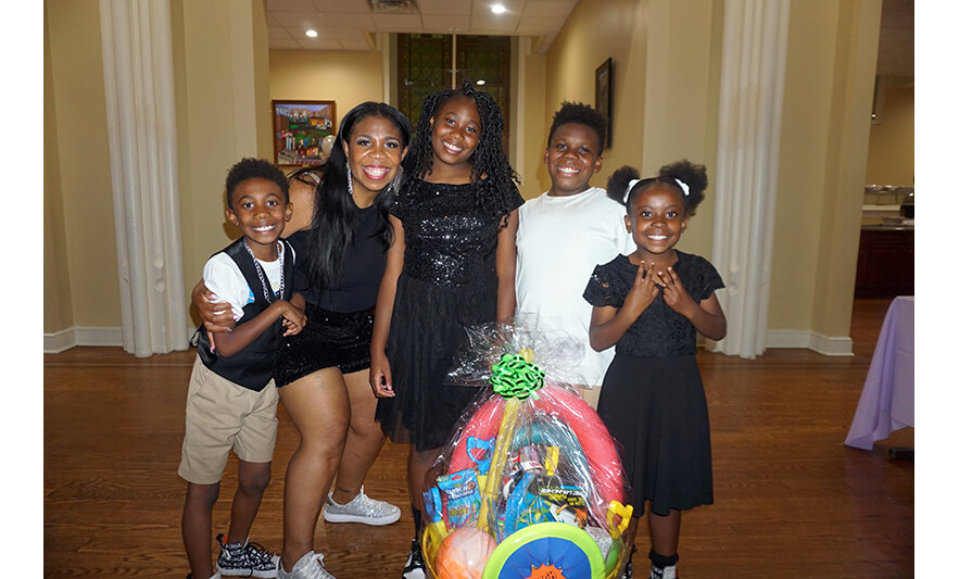 Youth Services Sneaker Ball Gala 6-10-2023 Family of 5 with basket for web