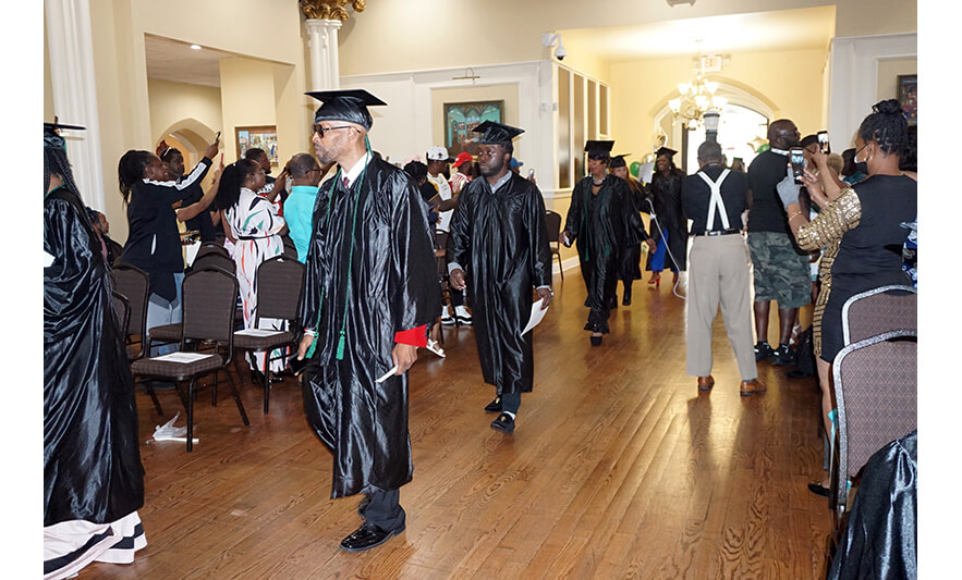 NCCTI Graduation 6-30-2023 Graduates walking in 2 for web