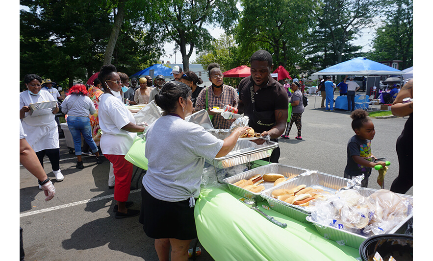 New Community Health Fair 7-27-2023 Serving hot dogs for web