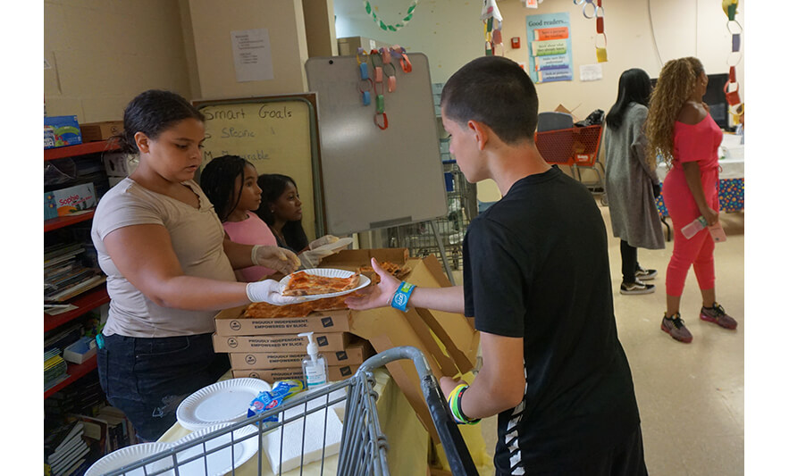 Harmony House Back to School 8-28-2023 Boy getting pizza for web