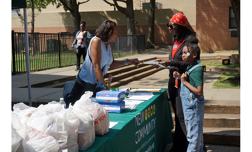 Manor Family Pop-Up 5-30-2023 Joann Williams-Swiney talking with woman and girl for web