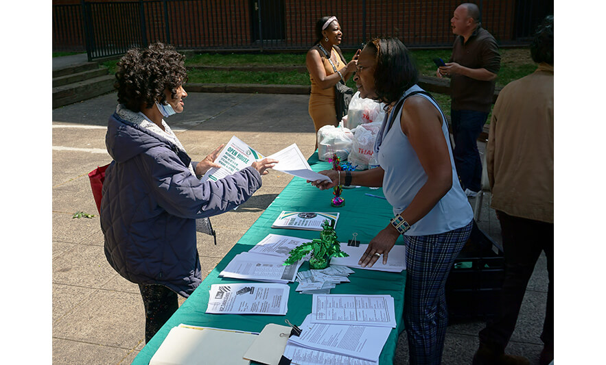Manor Family Pop-Up 5-30-2023 Woman taking papers from Joann Williams-Swiney for web