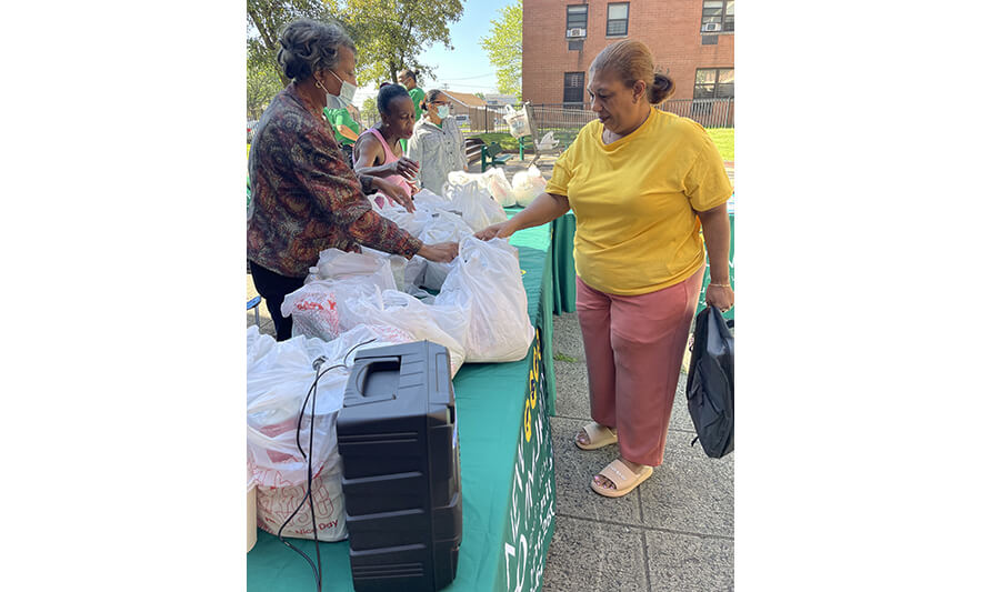 Manor Family Pop-Up 9-1-2023 from Joseph Woman in yellow getting bags for web