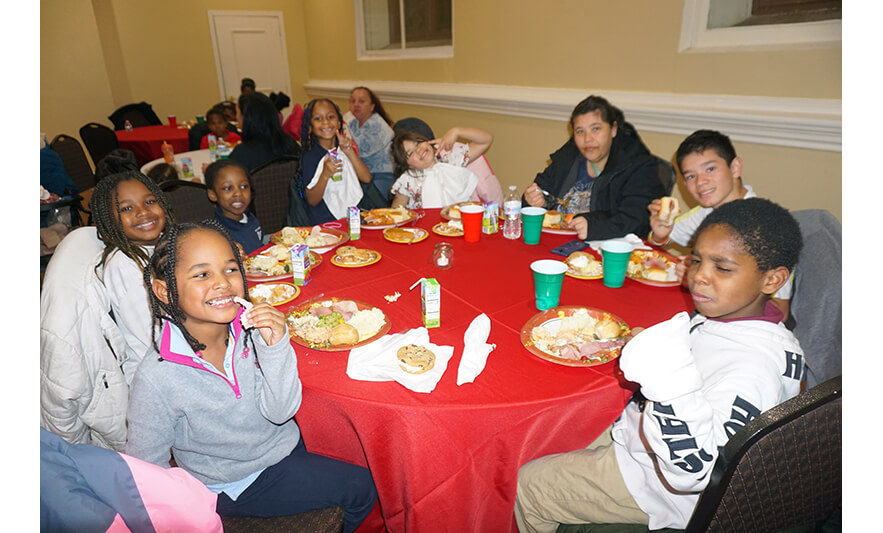 Withum Harmony House Thanksgiving 11-21-2023 Table with 7 kids for web