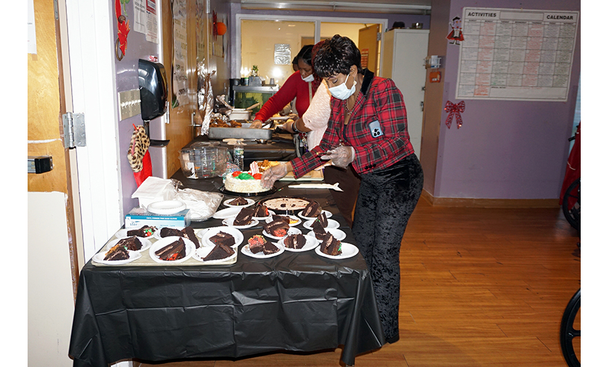 Extended Care 100th Birthday 12-13-2023 Veronica Onwunaka prepping cake for web