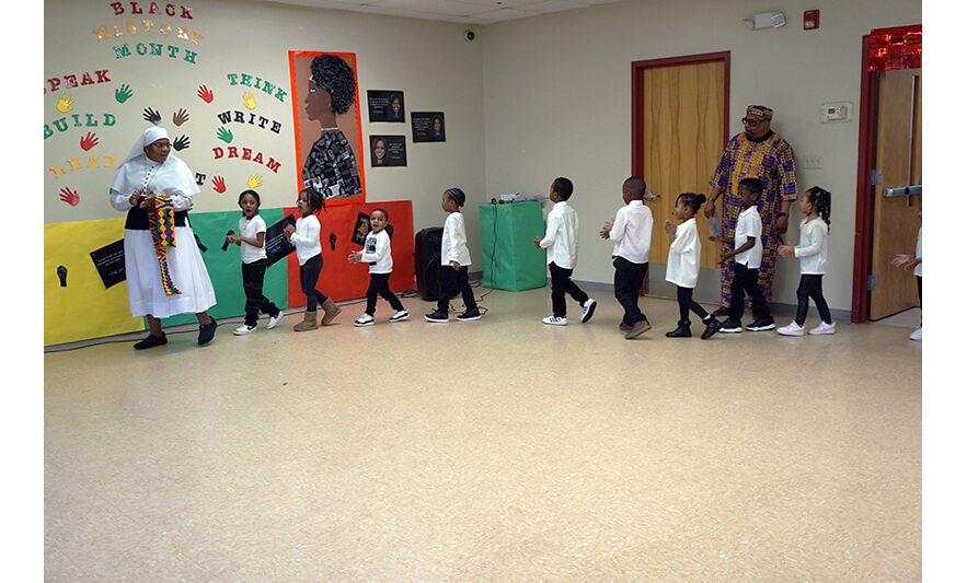 CHELC Black History Month 2-23-2024 Class in white shirts walking in for web