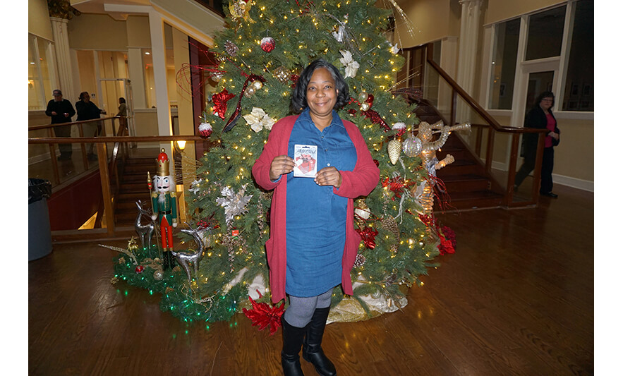 NCC Employee Holiday Party 12-14-2023 Gift card winner in red sweater for web