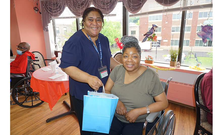 Extended Care Adopt-a-Resident Day 5-15-2024 Christiana Agbozo with woman in gray for web