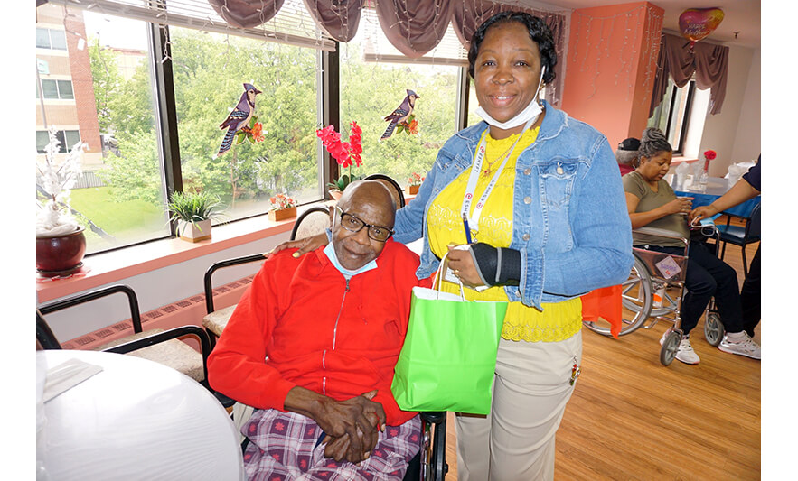 Extended Care Adopt-a-Resident Day 5-15-2024 Yonette Semple with man in red hoodie for web